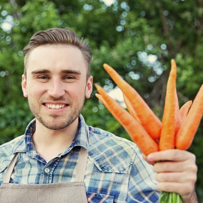 man holding carrots shutterstock 455450923